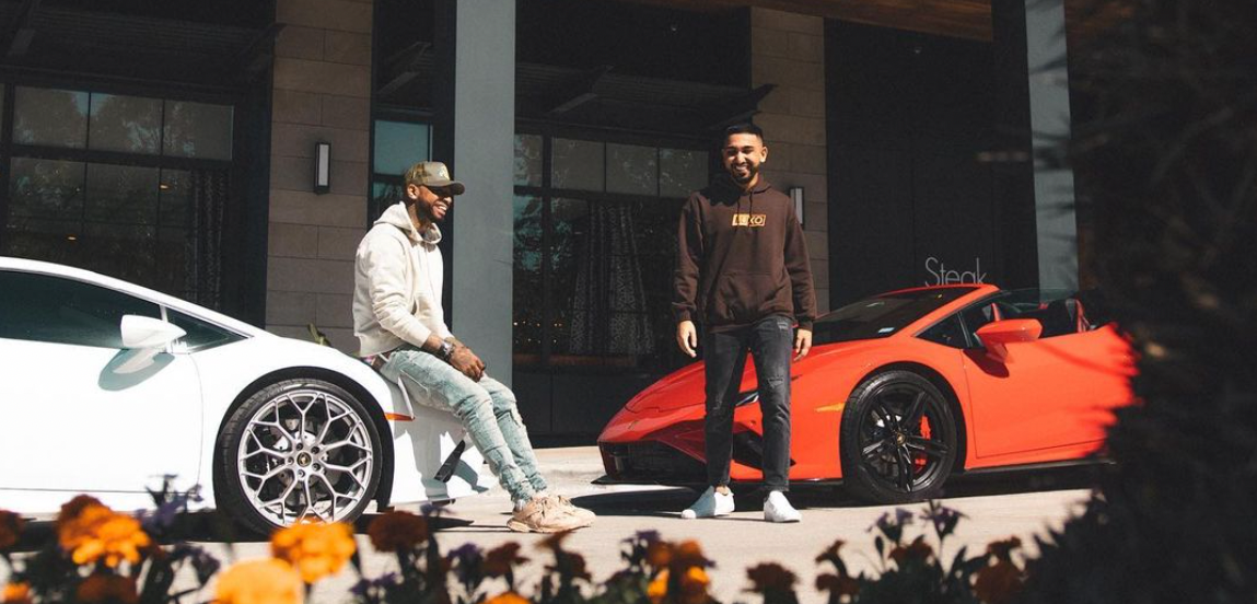Two young men with luxury cars